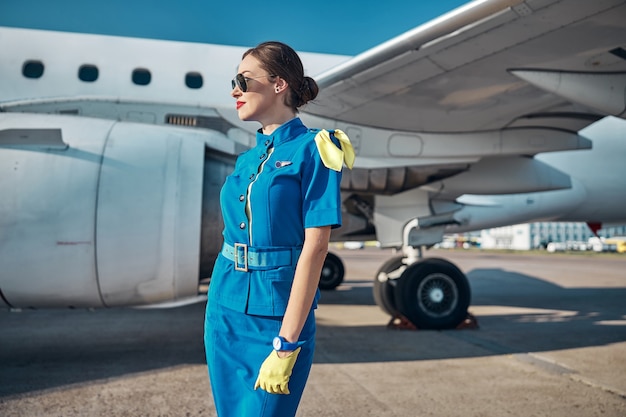 Smiling attractive stewardess getting ready to flight