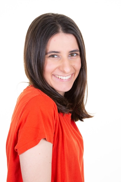 Smiling attractive young brunette woman posing in close up portrait in white studio shot