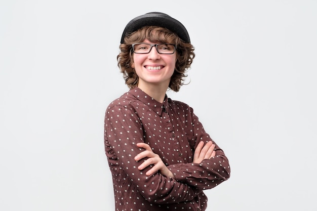 Smiling attractive young woman standing and looking at camera