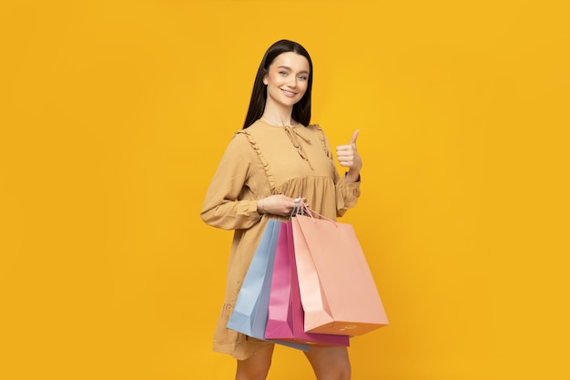 Smiling attractive young woman with shopping bags