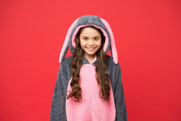 Smiling baby animal good morning to you comfortable homewear\
fashion small girl wear easter bunny costume happy kid in kigurumi\
pajama pajama for your cozy sleep funny rabbit child relax