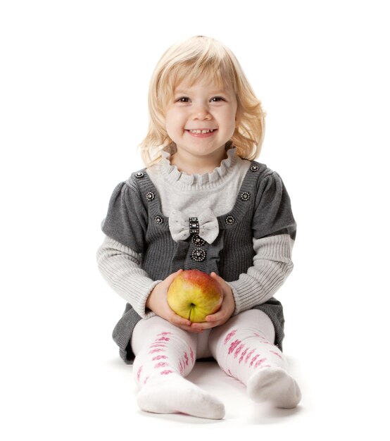 Smiling baby girl with apple