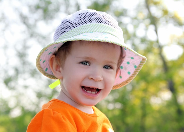 Smiling baby in hat outdoor