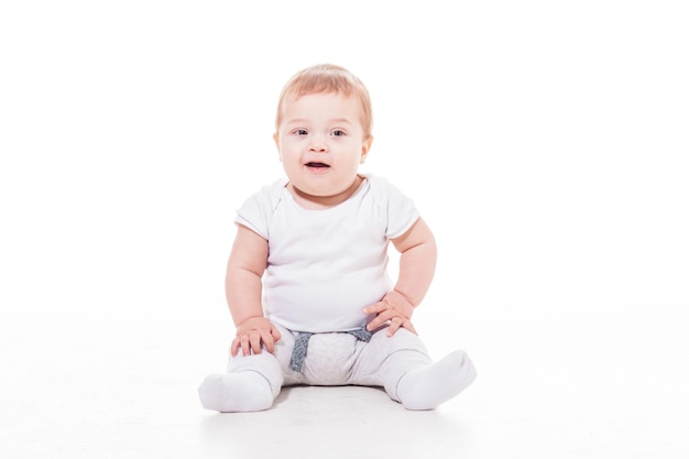 Smiling baby sitting on a floor