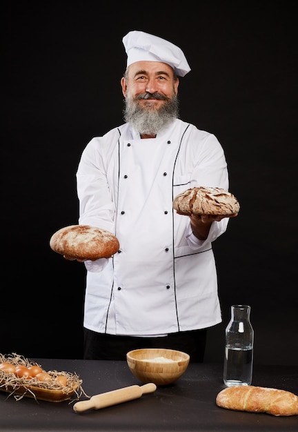 Smiling Baker Holding Traditional Bread