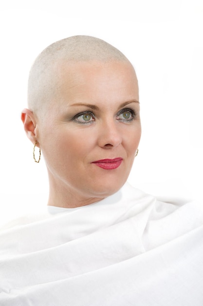 Smiling bald woman against white background