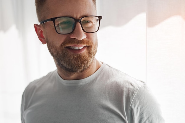 Smiling bearded man at home