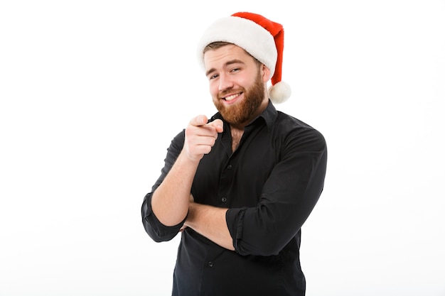 Smiling bearded man in shirt and christmas hat