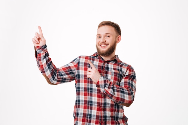 Smiling Bearded man in shirt pointing up