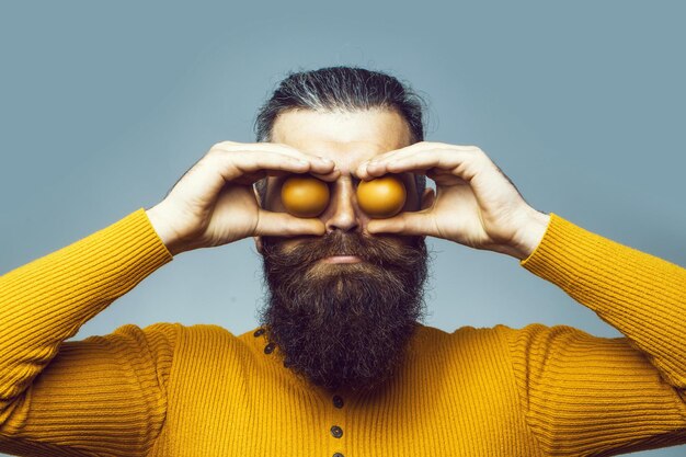 Smiling bearded man with egg