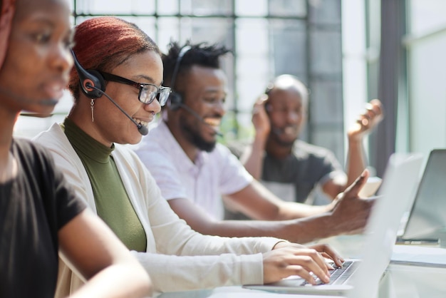 Smiling beautiful african american woman working in call center with diverse team