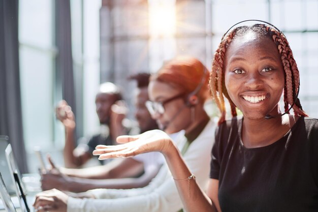 Smiling beautiful african american woman working in call center with diverse team