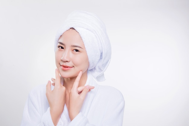 smiling and beautiful asian woman wearing bathrobe