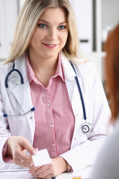 Smiling beautiful female medicine doctor explain diagnosis