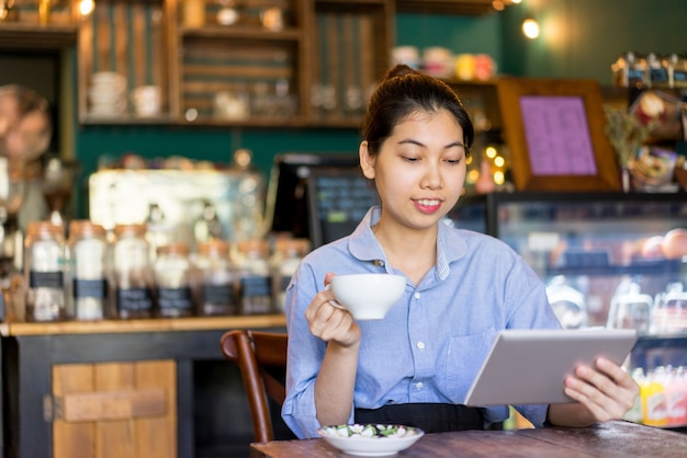 Smiling beautiful lady enjoying leisure in coffee house. 