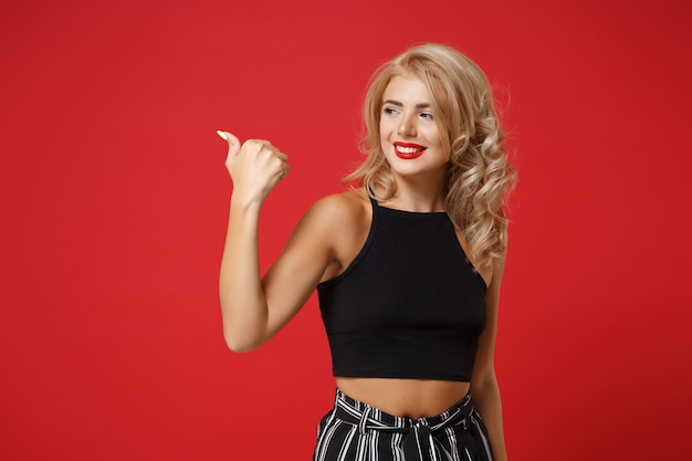 Smiling beautiful young woman in black clothes posing 