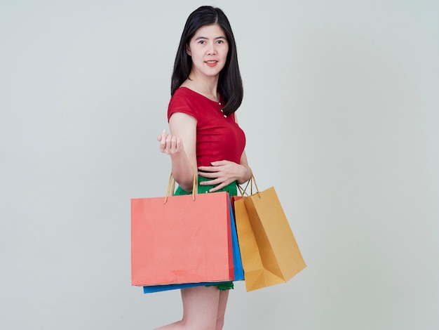 Smiling beauty woman with colorful shopping bags