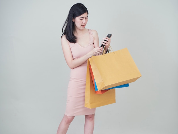 Smiling beauty woman with colorful shopping bags