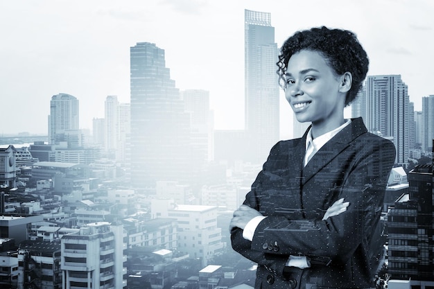 Smiling black African American business woman in suit in crossed arms pose Bangkok cityscape The concept of woman in business Investment fund Double exposure