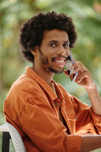 Smiling black man calling