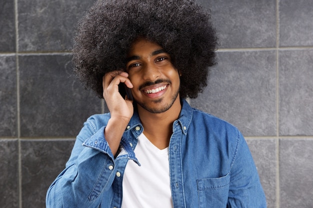 Smiling black man using cellphone