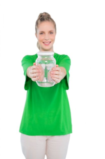 Smiling blonde activist holding glass jar