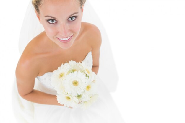 Smiling blonde bride looking up at the camera