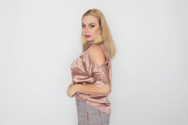 Smiling blonde business woman in pink blouse over white background