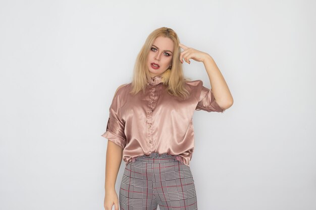 Smiling blonde business woman in pink blouse over white background