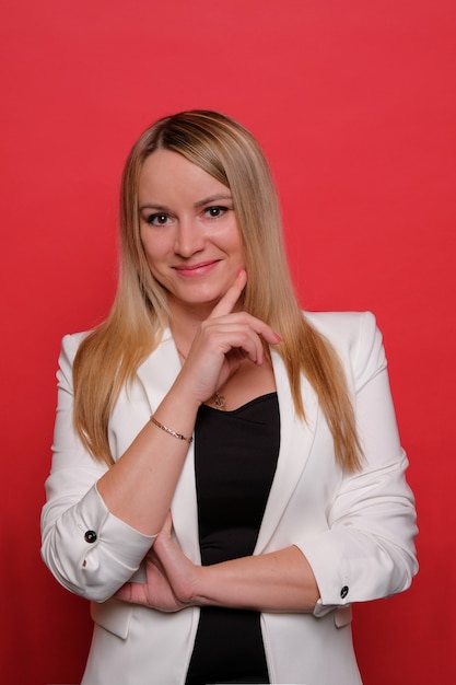 Smiling blonde girl in a white jacket