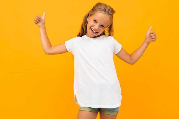 Smiling blonde girl in a white t-shirt with a mockup