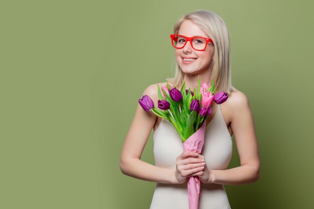 Smiling blonde girl with tulips