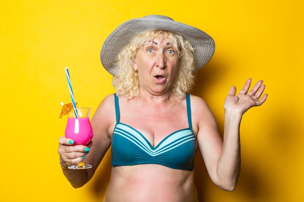 Smiling blonde old woman in swimsuit