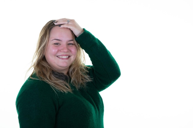 Smiling blonde oversize woman hand on hair in studio shot on white background