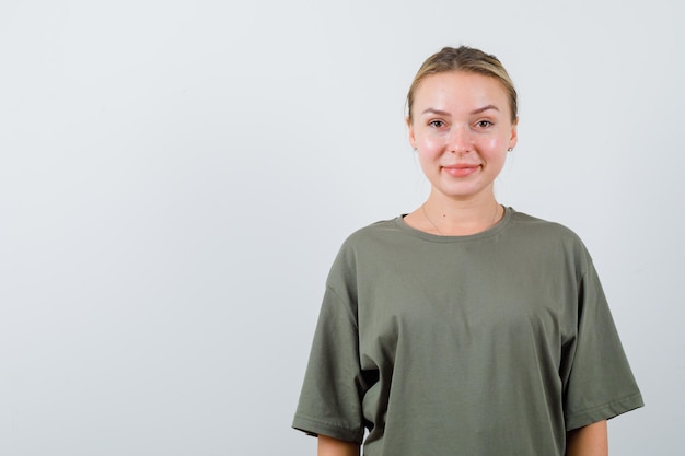 The smiling blonde woman is looking at camera on white background