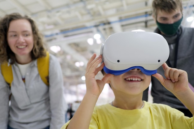 Smiling boy exploring virtual world in headset