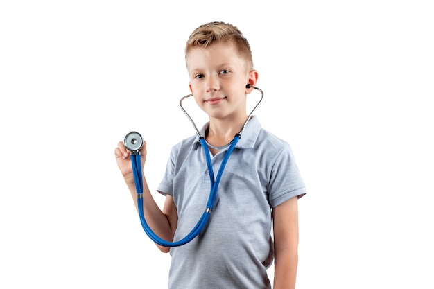 Smiling boy holding a stethoscope in his hands isolated on a white background