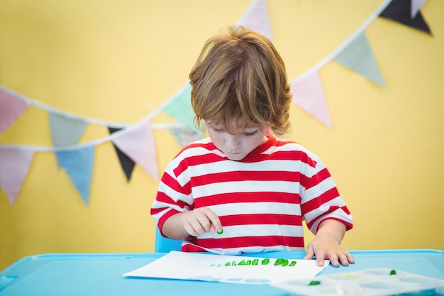 Smiling boy painting a picture