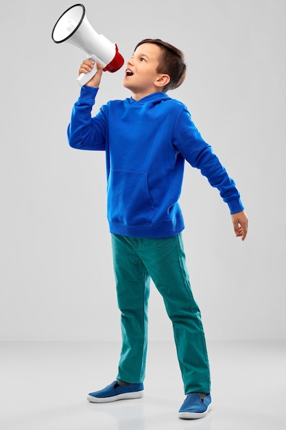 Photo smiling boy speaking to megaphone