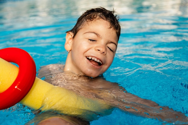smiling boy swimming in pool