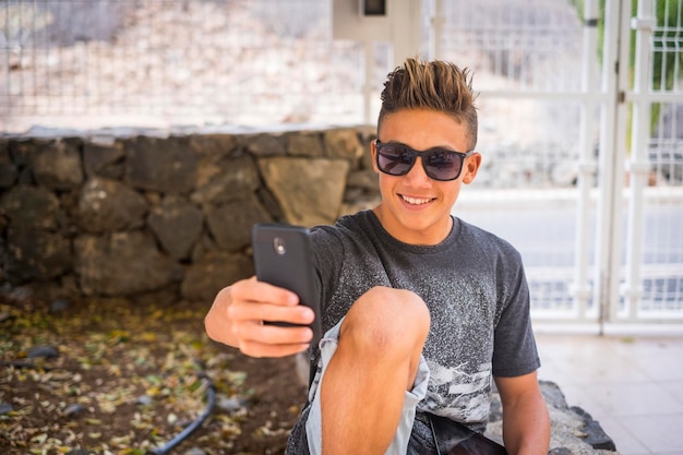 Smiling boy taking selfie