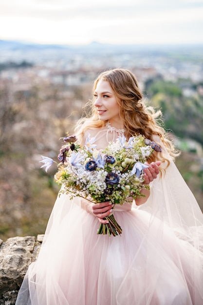 Smiling bride in a beautiful long pink dress