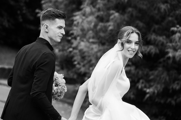 Smiling bride touching groom