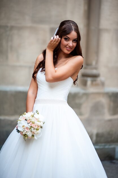 Smiling bride with wedding bouquet