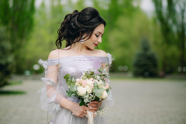 Smiling bridesmaid in front of green blurred natural background