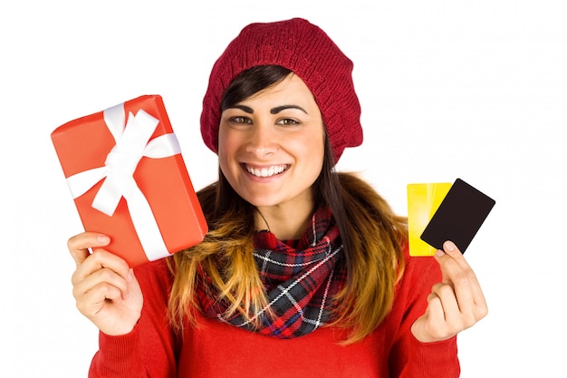 Smiling brunette holding gift and cards