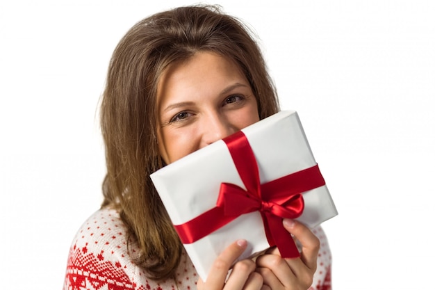 Smiling brunette holding a gift with red ribbon