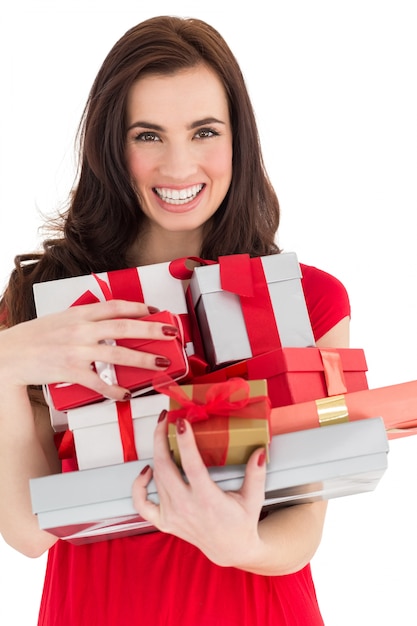 Smiling brunette holding many gifts