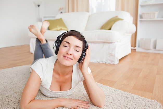 Smiling brunette listening to music