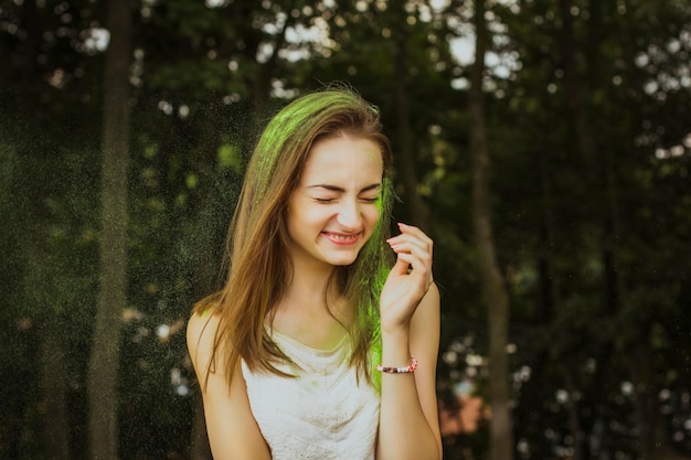 Smiling brunette woman with dry paint on her face